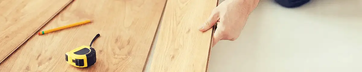 A professional installing wood flooring in Fort Collins, CO