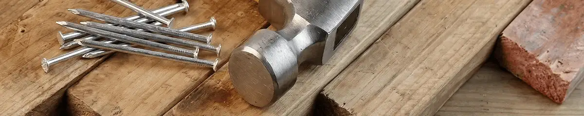 Hammer and nails on hardwood flooring boards in Fort Collins, CO