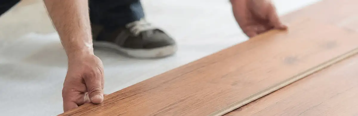 A professional installing laminate flooring in Fort Collins, CO