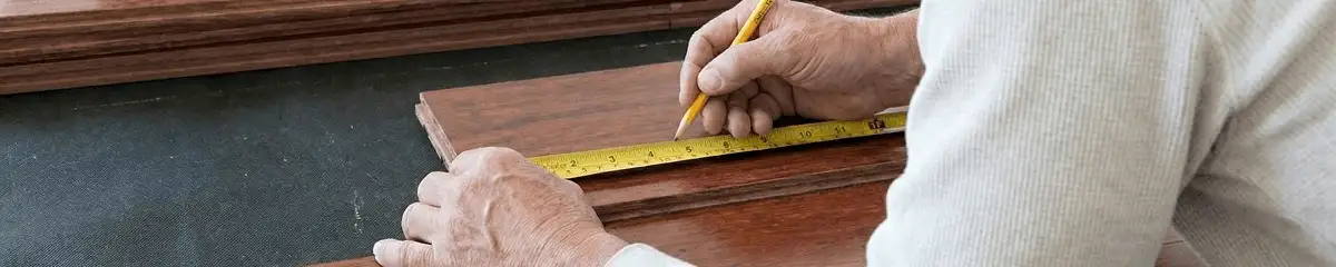 A professional installing wood flooring in Fort Collins, CO